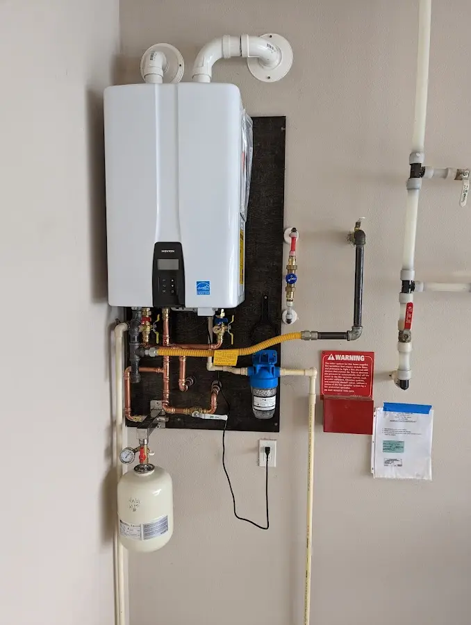 Professional plumber installing copper piping in a West Deptford home